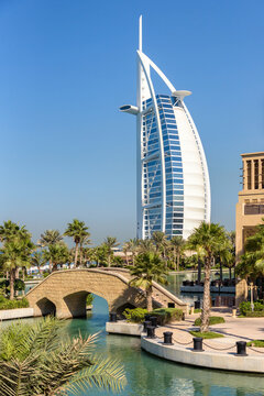 Scenic view of a stone bridge over water canal with Burj Al Arab luxury hotel in the background