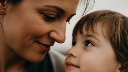 Fototapeta premium A tender moment between a mother and her young child, sharing a loving gaze.