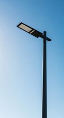 Streetlight Against a Blue Sky - Modern Urban Illumination.