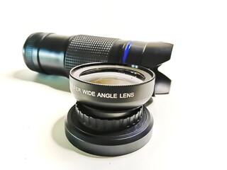 Professional super wide angle lens with monocular telescope isolated on white. High-quality optical equipment for photography, landscape shooting, and outdoor exploration.