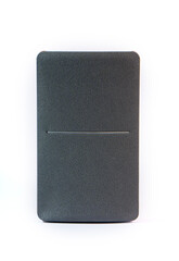 Wooden bookshelf speaker with a grey fabric front grille isolated on a white background. Modern minimalist audio equipment for home entertainment.