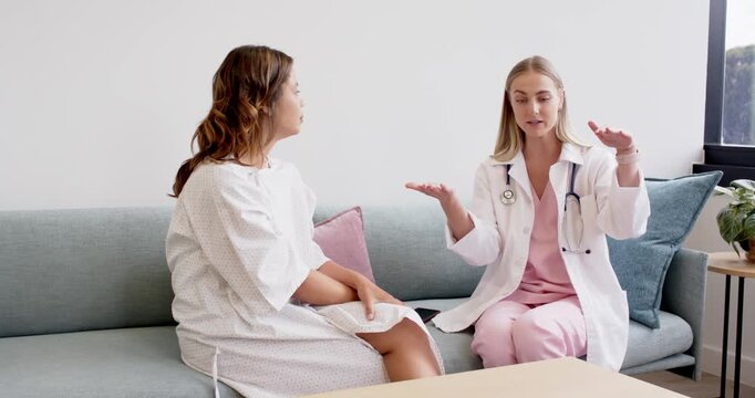 Provider and patient on couch during consult, provider explaining progression using stethoscope