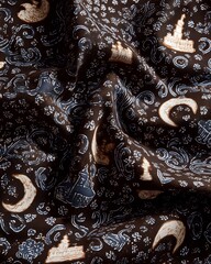 Traditional batik pattern for Ramadan featuring Islamic motifs like crescents and mosques in wax-resist dye on natural cotton fabric