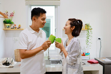 Woman and man boils water to make coffee to drink in the morning.