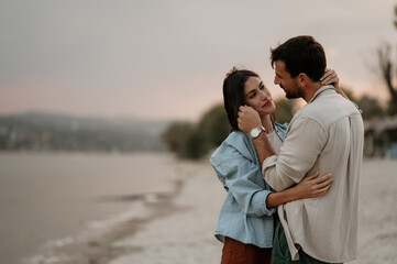 Romantic couple embracing on beach at sunset