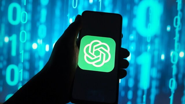 Hand holding smartphone displaying the chatgpt logo against a background of blue digital binary code, representing artificial intelligence and technology