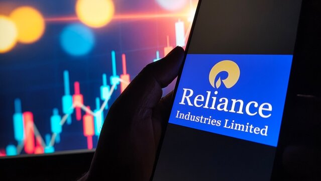 Reliance industries limited logo displayed on a smartphone screen with a stock market graph in the background