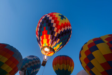colorful hot air balloons glowing against sky