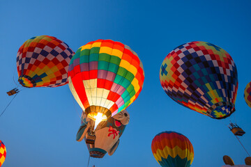 colorful hot air balloons glowing against sky