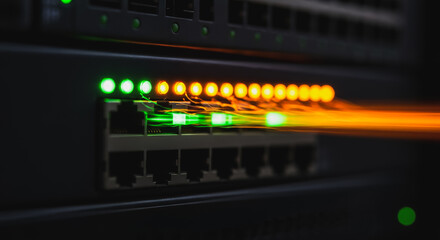 High-speed data flow on network switch ports with glowing LED lights and motion blur, symbolizing fast internet connectivity.