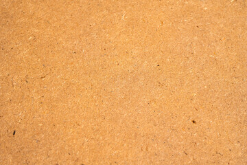 Close-up of brown cardboard texture background. Recycled paper surface with rough fiber details, suitable for vintage or eco-friendly design concepts.