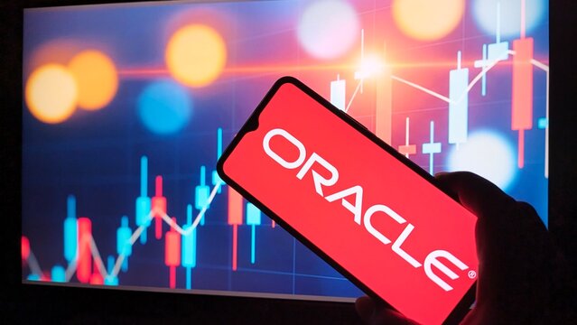 Hand holding smartphone displaying oracle logo over stock market chart background