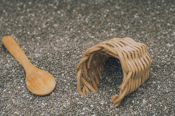 Chia seeds in a wooden bowl with a wooden spoon