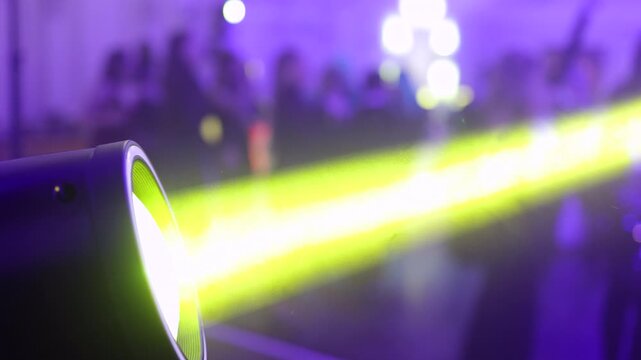 Moving Stage Light Beam Over Dancing Crowd