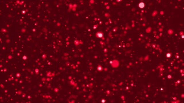 Red glowing particles floating on a dark background. Romantic abstract background for Valentine&rsquo;s Day