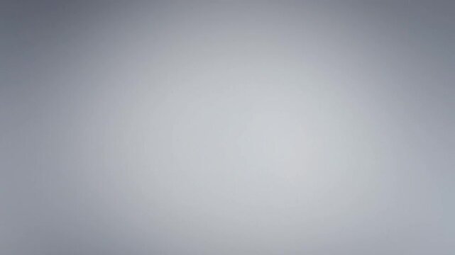 A close-up shot of a gray gradient background with a smooth transition from dark to light.