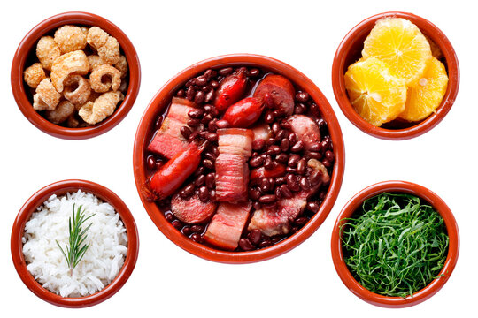 Traditional Brazilian feijoada isolated on a white background, accompanied by white rice, sliced ​​kale, orange, and pork crackling in clay bowls