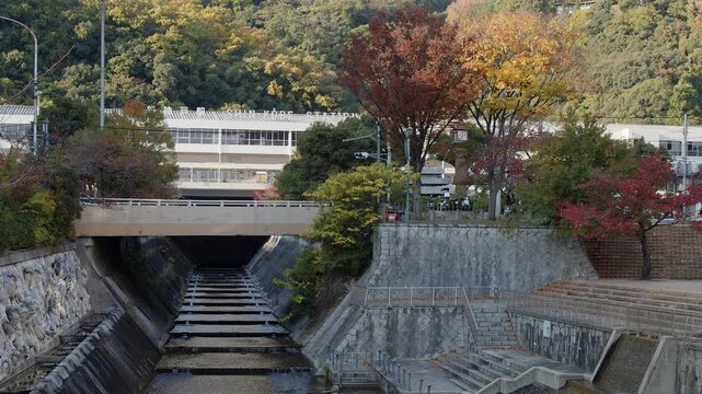 View up Ikutagawa River canal to Shinkobe railway station in Kobe Japan