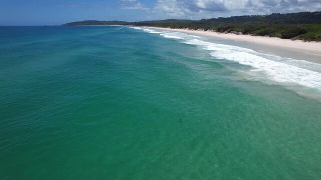 Sharks Swimming By Tallows Beach With White Sand And Turquoise Waters In Byron Bay, NSW, Australia. - aerial shot