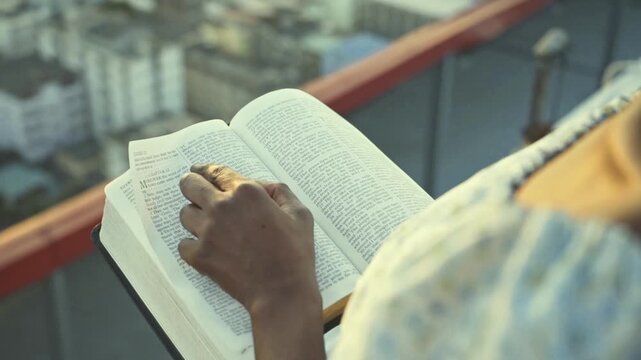 young black Woman afro american Reading Bible at Sunset Outdoors