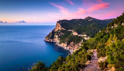Dramatic coastal cliffs at sunset with vibrant pink and purple sky over the ocean.