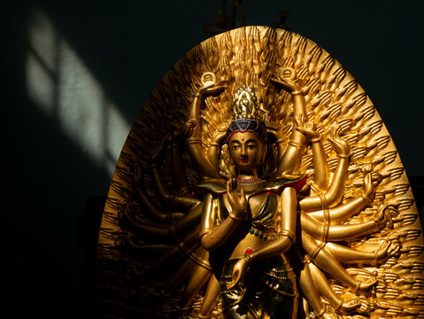 Ornate Golden Thousand-Armed Guanyin Bodhisattva Statue in Buddhist Temple