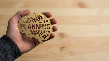 Ai brain planning no code automation concept hand hold wooden tech brain planning icon on table surface idea metaphor focus detail