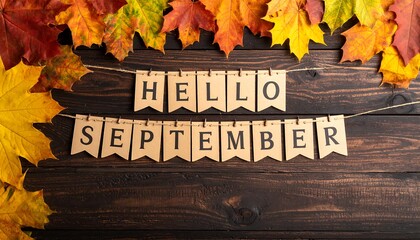 Autumnal image with vibrant foliage and a welcoming greeting strung across a rustic wooden backdrop. The leaves show colors of red, orange, and yellow