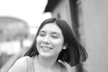 Happy teenager girl laughing out aloud.