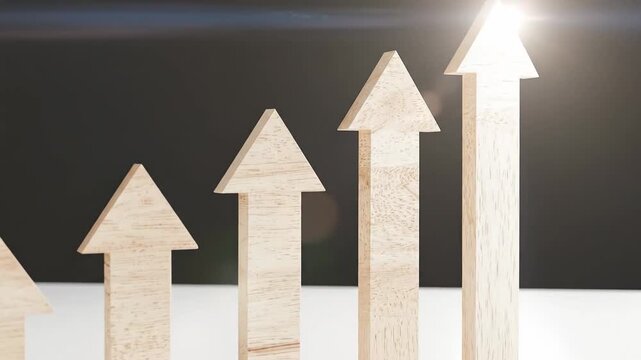 Wooden arrow blocks arranged in ascending order, symbolizing growth and progress.