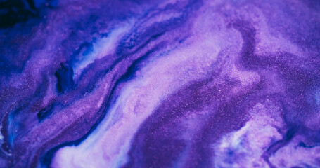 Paint spill defocused. Ink spread. Colorful shimmering dye abstract curl flow on acrylic texture. Purple blue neon wave stream background.