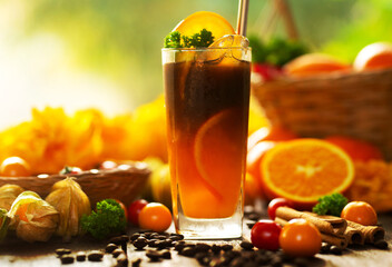 Iced Orange Espresso,Iced americano orange coffee in a glass decorated with fresh orange slice, cinnamon, and coffee beans on wooden table