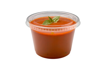 Tomato soup in plastic takeout container with basil garnish for Ramadan iftar, isolated on transparent background