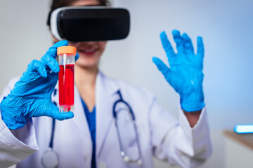 Fototapeta premium Female doctor wearing virtual reality headset examines blood sample during immersive medical simulation, combining digital healthcare technology,laboratory analysis,and innovative clinical training