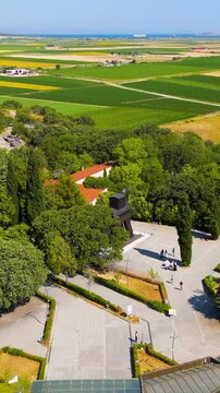 Vertical video. Tevfikiye, Turkey. Replica of the legendary Trojan Horse at the entrance to the archaeological site of Troy in Canakkale Province. Aerial view, Point of interest. Rich colors