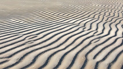 Ripples in sand on beach near ocean, abstract natural texture formed by wind and water at coastal sea shore during summer day