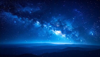 A breathtaking night scene features a celestial spectacle above a silhouette of rolling mountain ranges under the night sky