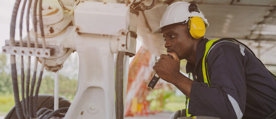 Mechanics inspect the engines of a large plane before takeoff at a summer airport.(PHOTO)