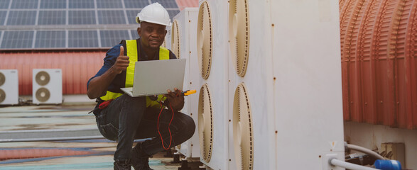 Engineers are checking the air conditioning and cooling system in a commercial building.(PHOTO)