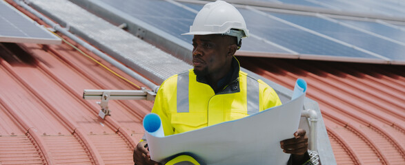 Engineers are checking the hot coil system of the rooftop air conditioner for green energy. Solar panels on the roof of the factory.(PHOTO)	