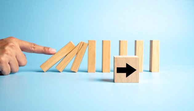 Hand pushing domino blocks with right arrow, chain reaction concept