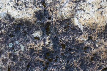 background, texture of stone mineralogical rocks in nature on a sunny day in a mountainous area, soft focus