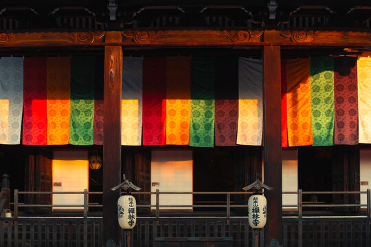 Colorful Traditional Japanese Temple Facade with Lanterns and Patterned Curtains in Kyoto