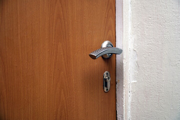 Door handle and keyhole on wooden door