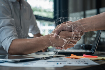 Global business partnership concept showing handshake with world map overlay, representing international trade, logistics, finance, and digital network connection across global markets.