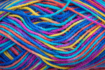 Close up of colorful knitting yarn. Colorful wool texture. Close up of colorful fabric.