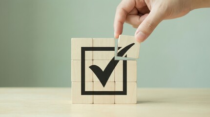 Hand Placing Wooden Block to Complete a Check Mark in a Box Icon Symbolizing Success Approval and Task Completion
