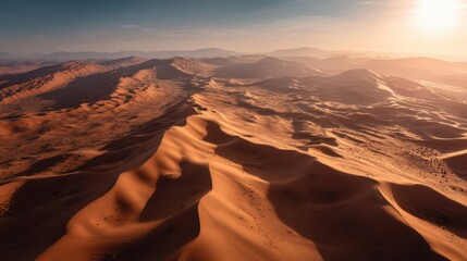 Desert landscape with a sun in the sky. The sun is setting and the sky is a beautiful orange color