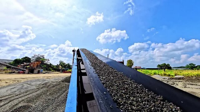 5-10 Aggregate Moving on Conveyor Belt at Aggregate Cleaning Plant Under Blue Sky