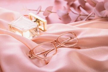 Assortment of eyeglasses, womens glasses on bright pink background
